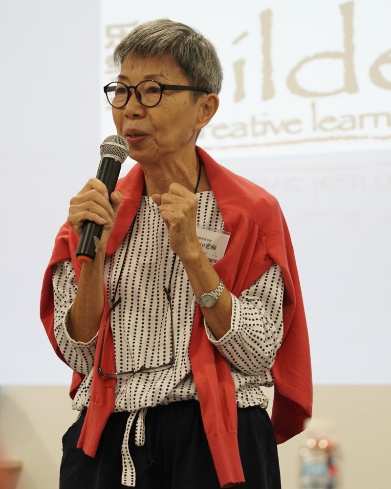 Jackie Loh, founder of bilden Creative Learning, speaking in front of the bilden logo
